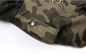 Close-up of military camouflage jacket shoulder strap and embroidered badge detail