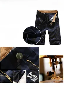 Detailed close-up of navy camo cargo shorts showing zipper, stitching and cotton texture