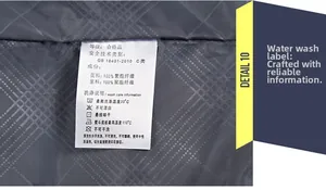 Close-up of garment wash care label showing 100% polyester material and fabric details