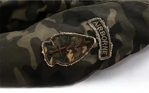 Detailed view of camouflage jacket fabric with high-quality Airborne military embroidery