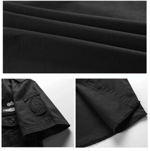 Close-up of black tactical shirt fabric showing twill texture and Airborne sleeve patch
