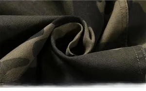 Macro shot of high-density camouflage textile fabric with rugged military canvas texture