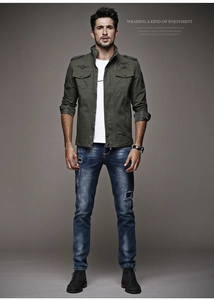 Detail of military green canvas jacket with epaulettes and chest pockets on male model