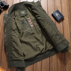 Men military green flight jacket with vintage interior lining print on wood background