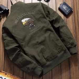 Men's military green bomber jacket with eagle embroidery on wood background