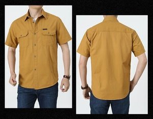 Detail view of mustard cotton cargo shirt featuring dual chest pockets and twill texture