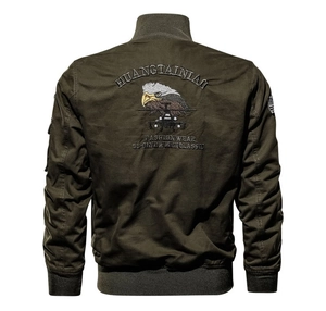Detail of army green military bomber jacket featuring intricate eagle embroidery on the back