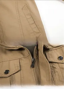 Detailed view of the tan cotton cargo jacket featuring metal zippers and pocket design