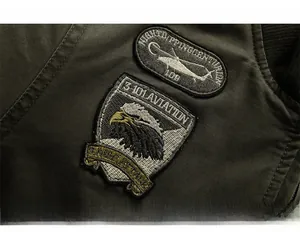 Detailed embroidery patches on olive green cotton military jacket with eagle and helicopter