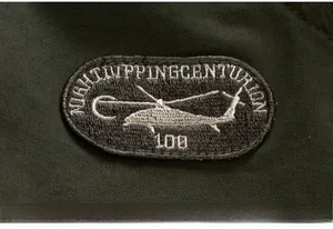 Detail of military helicopter embroidery patch on dark green heavy fabric jacket