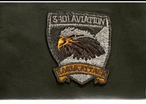 Detail of high-density embroidered military eagle patch on green twill jacket sleeve