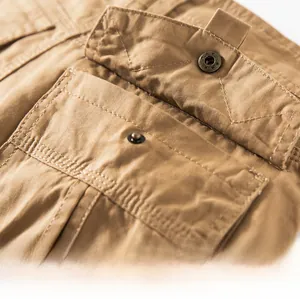 Macro shot of khaki cargo shorts showing reinforced back pocket with flap and metal button