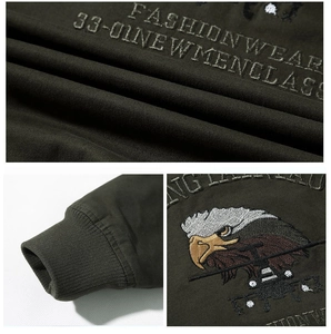 Detailed embroidery of an eagle patch and fashion lettering on an army green bomber jacket