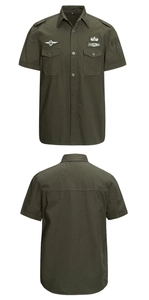 Detail of military green cotton short sleeve shirt with chest pockets and army patches