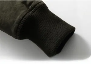 Detail of heavy canvas sleeve cuff with thick ribbed knit on deep olive military jacket