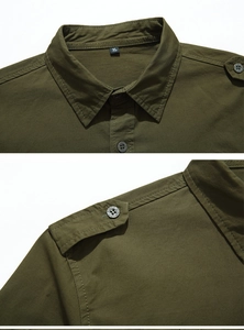 Detailed macro view showing the epaulet design and cotton fabric texture of the army green shirt