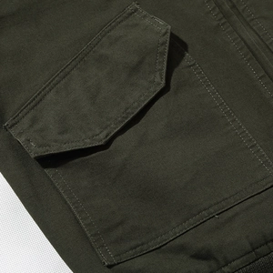 Men's olive green flight jacket featuring durable canvas fabric and a square utility pocket