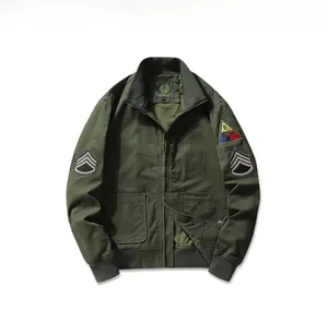 Detail view of military green flight jacket with embroidered arm patches and ribbed cuffs