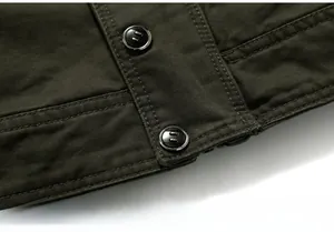 Detailed view of dark olive green cotton jacket hem with double stitching and black buttons