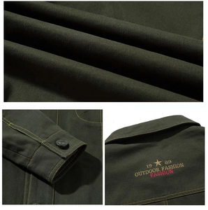 Detail of military green cotton jacket showing heavy-duty canvas texture and embroidery