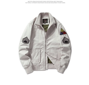 Detail of vintage military flight jacket with shoulder patches and ribbed collar stand