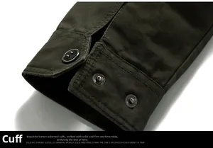 Detailed macro view of the olive green cotton jacket cuff with button closure