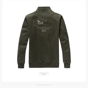 Detail of army green bomber jacket back featuring shark embroidery and military patches