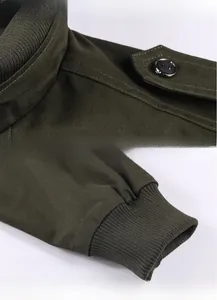 Detailed views of shoulder straps, buttons, and ribbed cuffs on the green military jacket