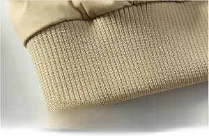 Detail of khaki military flight jacket featuring durable ribbed hem and double-stitch sewing