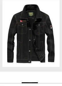 Detail view of black workwear jacket featuring contrast yellow stitching and outdoor patches