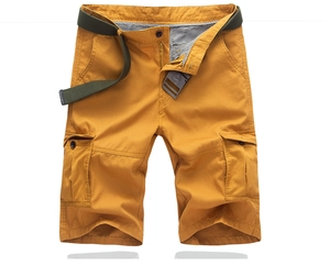 Detail of mustard yellow cargo shorts showing side pockets and woven canvas belt