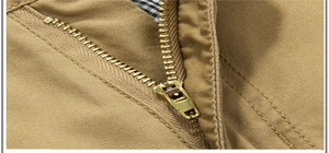 Detail of high-quality metal zipper and reinforced double stitching on khaki cargo shorts