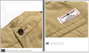 Macro detail of vintage plastic button and woven brand label on khaki cargo shorts