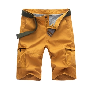Loose cargo shorts in mustard yellow with green canvas belt and large side pockets