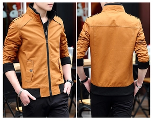 Detail view of mustard yellow cotton jacket with stand collar and shoulder epaulets
