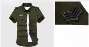 Close-up of military-style sleeve patch and pocket details on olive short sleeve shirt