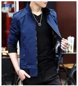 Detail of navy blue casual jacket with shoulder straps and metal zipper on model outdoors