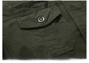 Detail of army green thick cotton jacket with utility pocket and reinforced stitching