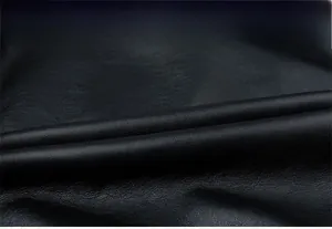 Detailed macro view of black PU leather texture showing grain and professional sewing quality