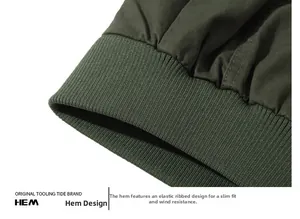 Detail of army green cotton jacket showing elastic ribbed hem for windproof protection
