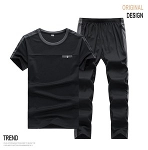 Detailed flat lay of men's black quick-dry sports set with grey stripe detailing