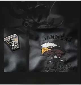 Close-up of eagle head embroidery and premium faux leather texture on motorcycle jacket