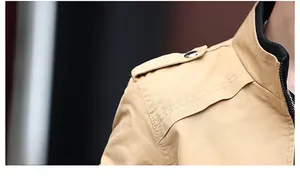 Macro detail of epaulets with silver buttons and triple stitching on khaki cotton jacket