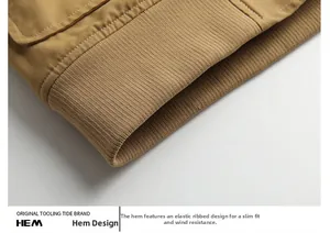 Detailed close-up of the khaki bomber jacket featuring elastic ribbed hem and stitching