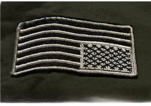 Close-up of military embroidered patch on army green twill fabric of casual men's jacket