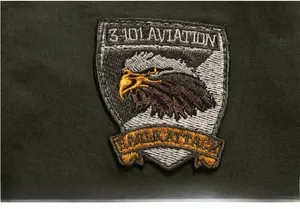 Detail of embroidered aviation eagle patch on green military cotton jacket sleeve