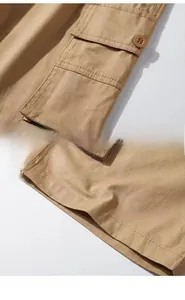 Detail view of khaki cargo shorts showing functional buttoned pockets and stitched hems