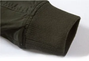 Close-up of military green jacket cuff with rib knit detail and cotton twill texture