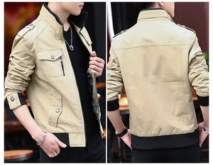 Detail view of khaki military jacket with shoulder tabs, flap pockets and plaid lining