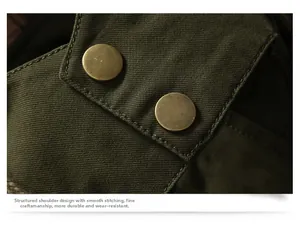 Detail of shoulder epaulettes with brass buttons on olive green heavy canvas work jacket